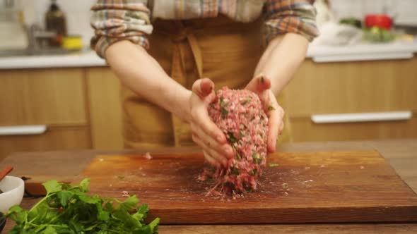 Crop woman beating minced meat