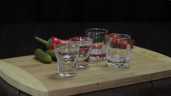 Pour Vodka From a Bottle Into Three Glasses