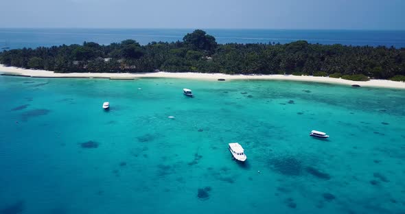 Natural fly over travel shot of a white paradise beach and aqua turquoise water background