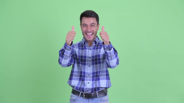 Happy Young Hispanic Man Giving Thumbs Up and Looking Excited