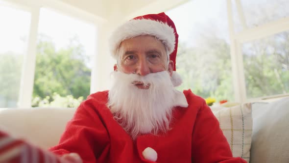 Portrait of senior man at christmas time  wearing santa costume