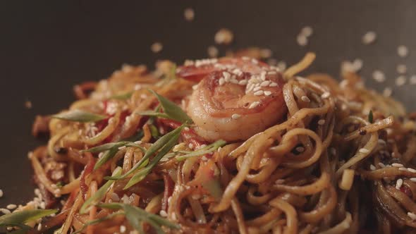 Professional Cook Frying Vegetables with Noodles