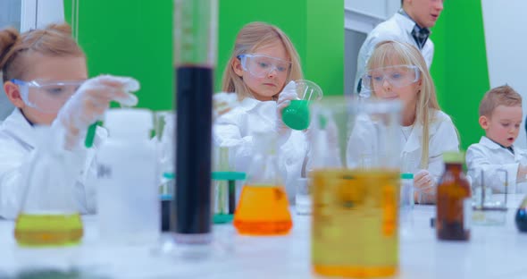 Children Studing Chemistry in School Laboratory