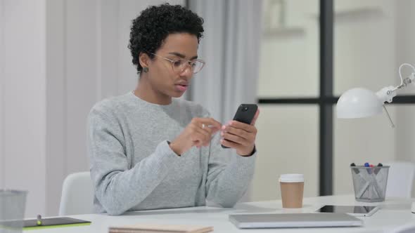 African Woman Using Smartphone at Work