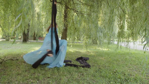 Girl Does the Splits While She Holding Aerial Silk