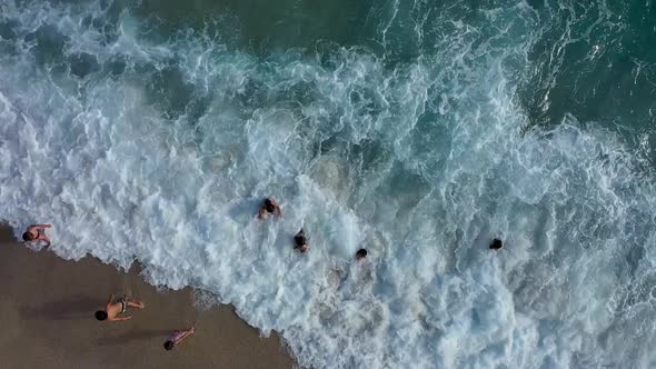 Children Play on the Waves of the Sea