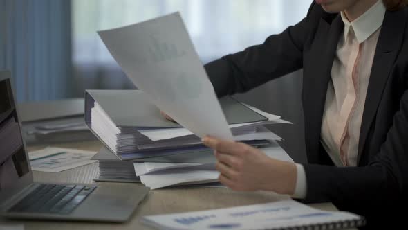 Woman Overloaded With Paperwork Putting Head on Folders Pile, Working Long Hours