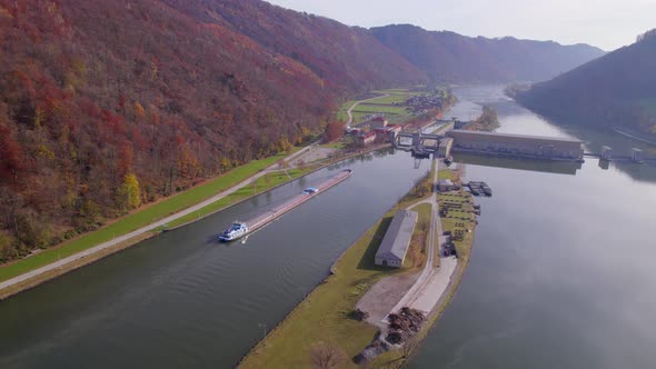 Cargo Pusher Transport Boat Traversing a Lock Moving Freight and Goods