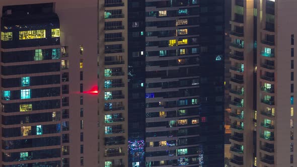 Windows in Highrise Building Exterior in the Late Evening with Interior Lights on Timelapse