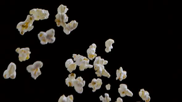 Popping Popcorn Flying and Falling Isolated on Black Background