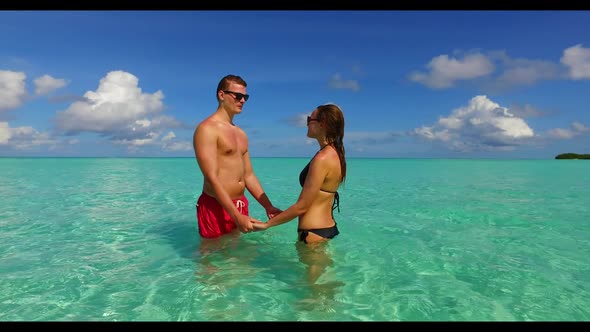 Man and woman in love on tropical shore beach time by blue sea with white sand background of the Mal