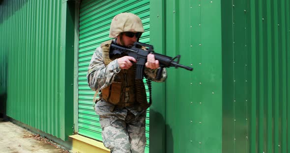 Military soldier guarding with a rifle alt