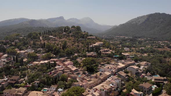 AERIAL: Overview shot of beautiful village on the hills in mallorca