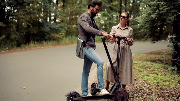 Driving Ecology Transportation. Man Ride Electric Scooter Mobility. Drive Electric Scooter In City.