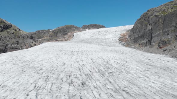 Aerial: glacier ice sheet, crevasses and cracks in Hardanger glacier Norway