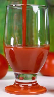 Poured Freshly Tomato Juice Into Empty Transparent Glass Next to Lie Fresh Ripe Natural Tomatoes