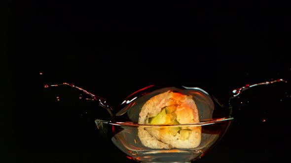 Super Slow Motion Shot of Fresh Sushi Falling Into Soy Sauce Isolated on White at 1000Fps