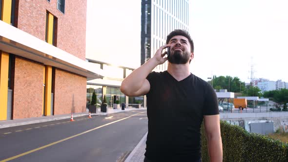 Happy Businessman Talking on the Phone While Walking