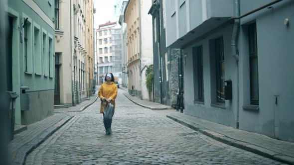 Narrow Street and a Lady Happily Walking Along It