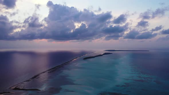 Aerial above panorama of perfect lagoon beach break by blue ocean with white sandy background of a p