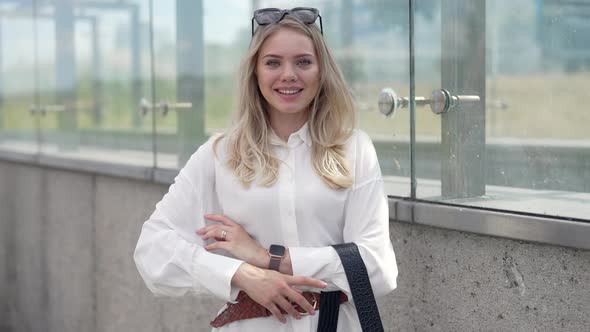 Young Businesswoman Walking Outside Modern Building