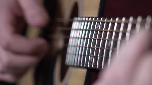 Man Starts Playing Guitar, Dynamic Change of Focus, Close Up