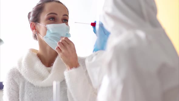 Woman Undergoing PCR Test in Doctor Office During Coronavirus Epidemic Closeup