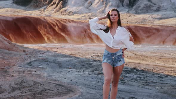 Beautiful woman posing on other-worldly hilly landscape