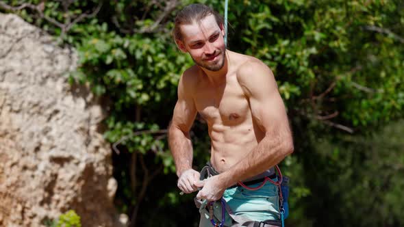 Athletic Man Confident After Rock Climbing Cliff Proud of His Achievement