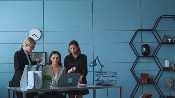 Women at a business meeting talking to colleagues about a new project