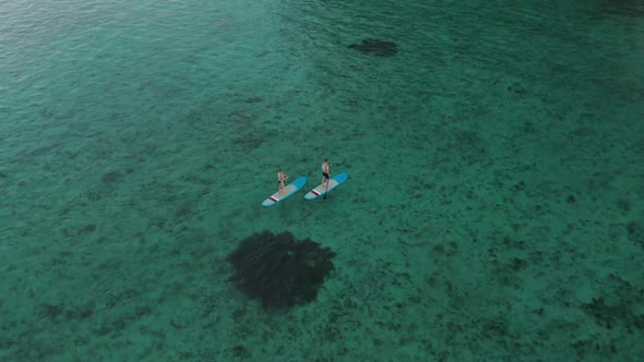 Surfers Couple on Surfing Board Man and Woman Swimmers Relaxing on Blue Surfboards Top View