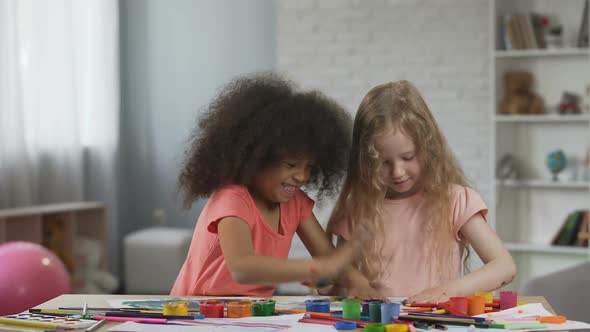 Little Multiracial Friends Making Colorful Handprints on Papers, Having Fun