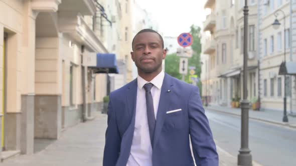 African Businessman Walking on Street