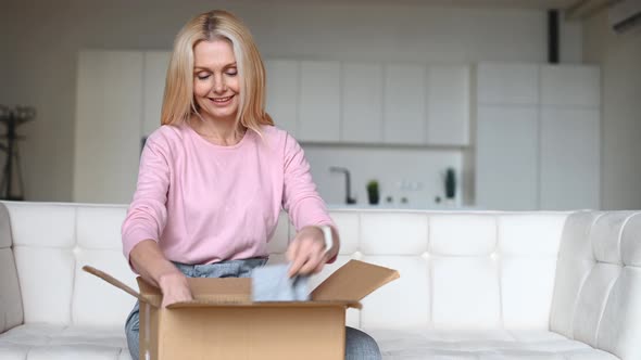 Middleages Woman Unpacking a Shipment Box