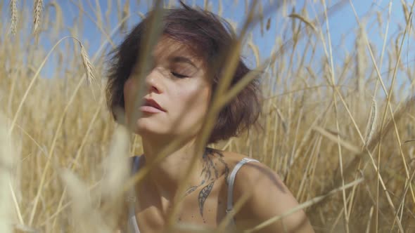 Brunette Woman with Short Hair on the Wheat Field