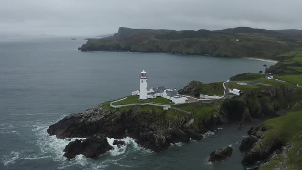 Aerial drone establishing shot of Fanad Head Lighthouse in Northern Ireland