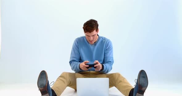 Man playing joystick game on laptop 