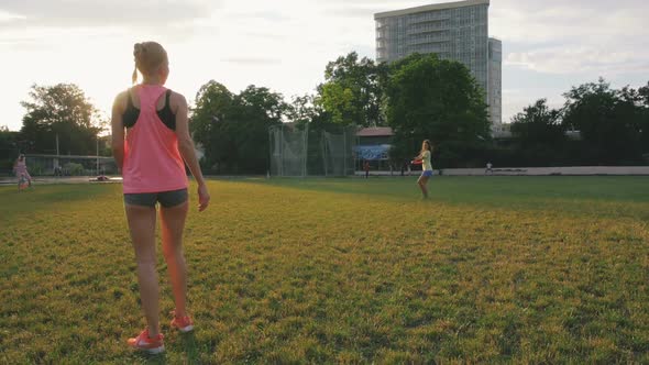 Two Young and Beautiful Women Playing Frisbee in the Park Slow Motion