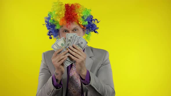 Clown Businessman Entrepreneur Boss in Wig Shows Tricks with Money Banknotes
