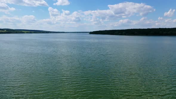 Evening water under blue sky. Beautiful wide river landscape. 