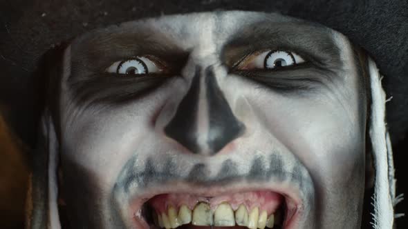 Close-up Man Face in Skeleton Halloween Cosplay Removing Hands From Face and Looking Wide Open Eyes