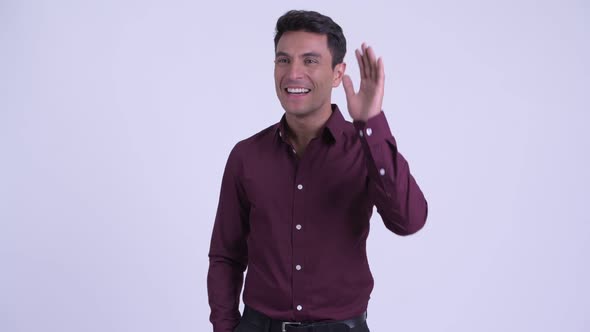 Young Happy Hispanic Businessman Waving Hand