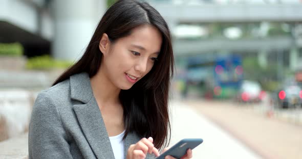 Business woman use of smart phone in city 