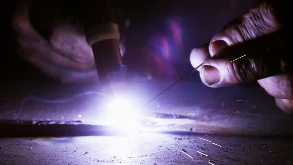 Close-up of welder using welding torch