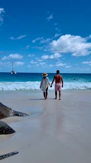 Anse Georgette Praslin Seychelles Young Couple Men and Woman on a Tropical Beach During a Luxury