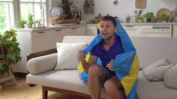 A Swede Male Football Fan Supports the National Team with the Swedish Flag