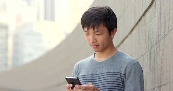 Man use of mobile phone in city