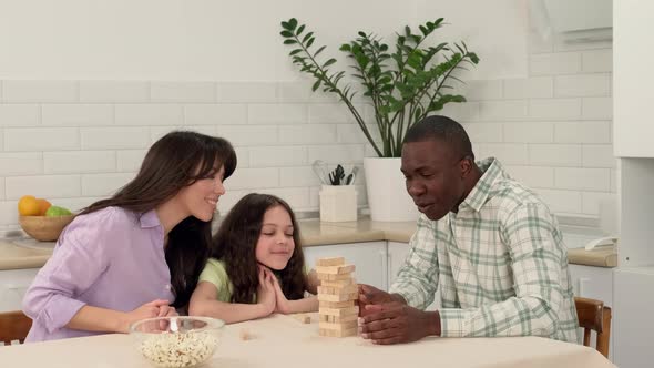 Cheerful Family of Different Races Play Board Game at Home