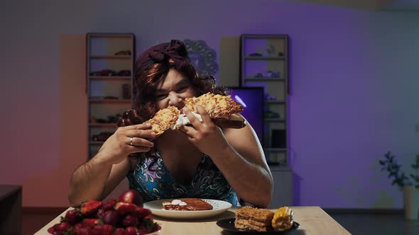 Man Dressed in Woman's Dress and Makeup on Face Eats a Huge Sandwich