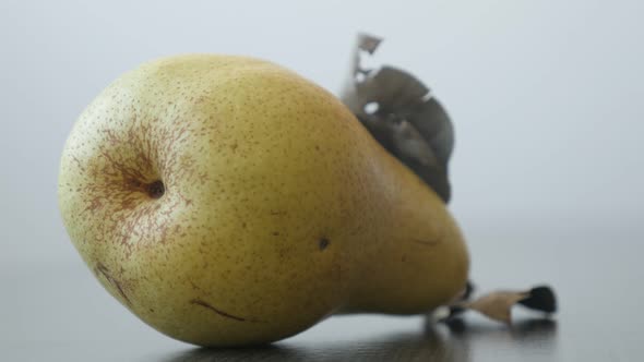 Tasty fruit from genus Pyrus 4K 2160p UltraHD tilting footage - Close-up of yellow organic pear on t